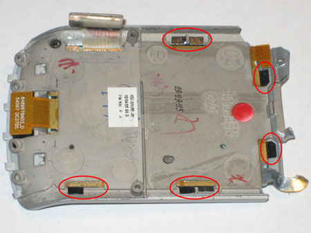 Lift the metal tabs, as circled to remove the keypad